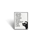 Soulpurrpose enamel pin with 'Never trust a man who doesn’t like cats' text and black cat illustration.