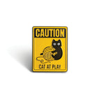 Yellow caution sign pin with black cat playing with yarn ball, Soulpurrpose themed accessory.